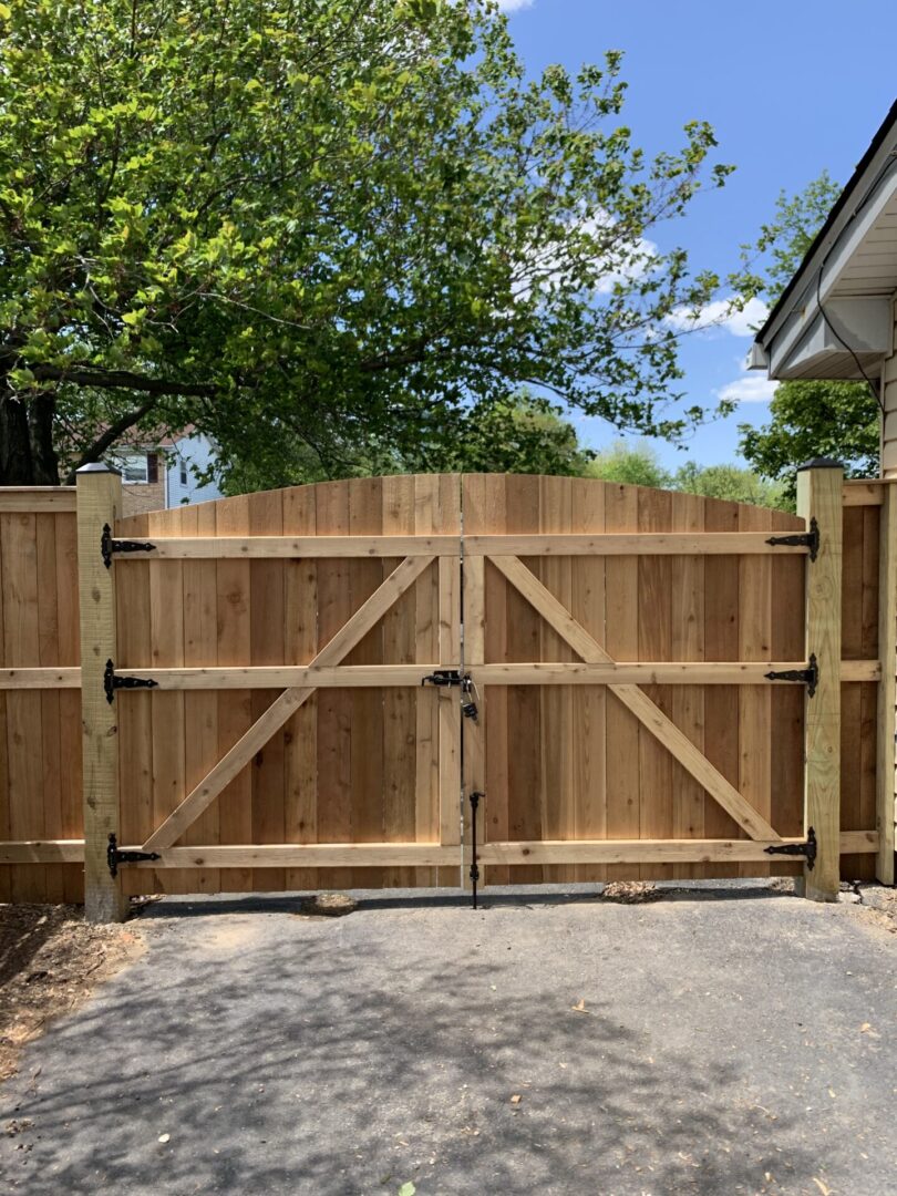 A wooden gate with two metal bars on it.