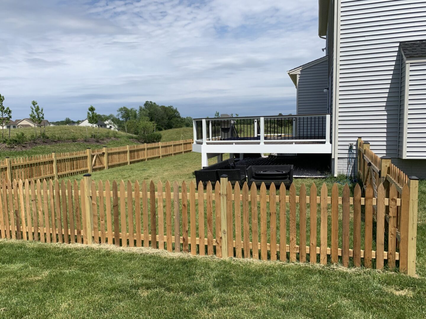 A wooden fence in front of a house.