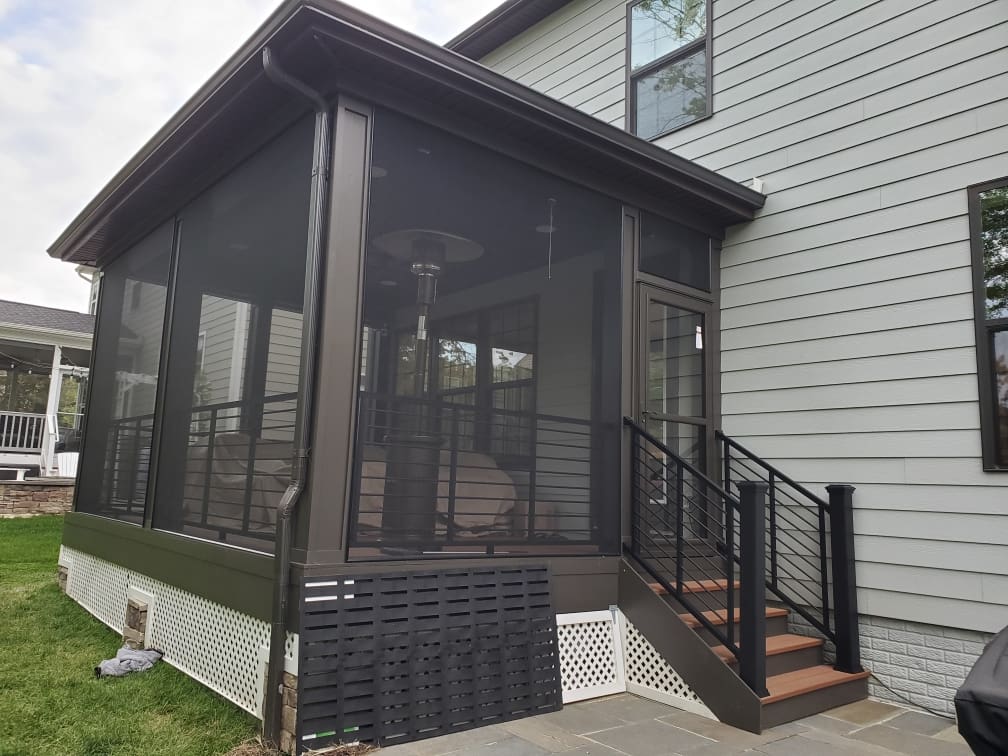 A porch with stairs leading to the back of it.