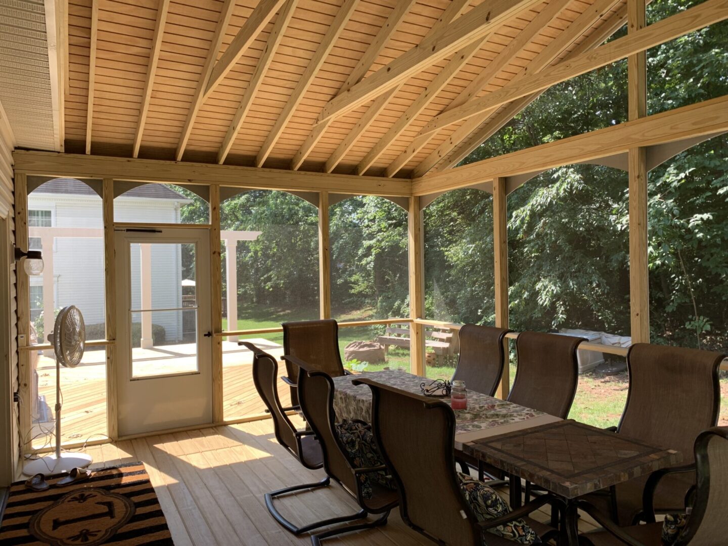 A patio with chairs and tables in the middle of it.